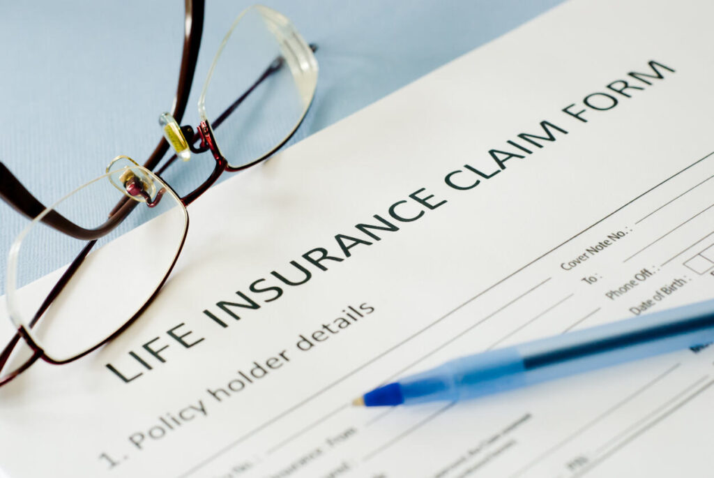 Life insurance claim form with pen 