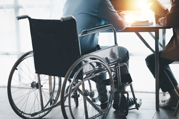 handicap is sitting on the table and discussing about disabilty insurance