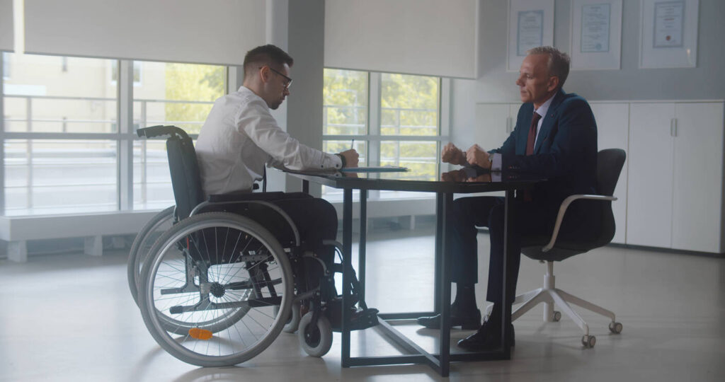 handicap men is sitting in front of Lawyer